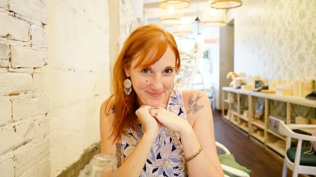 Amy Ewing, author and editor, seated in a cafe